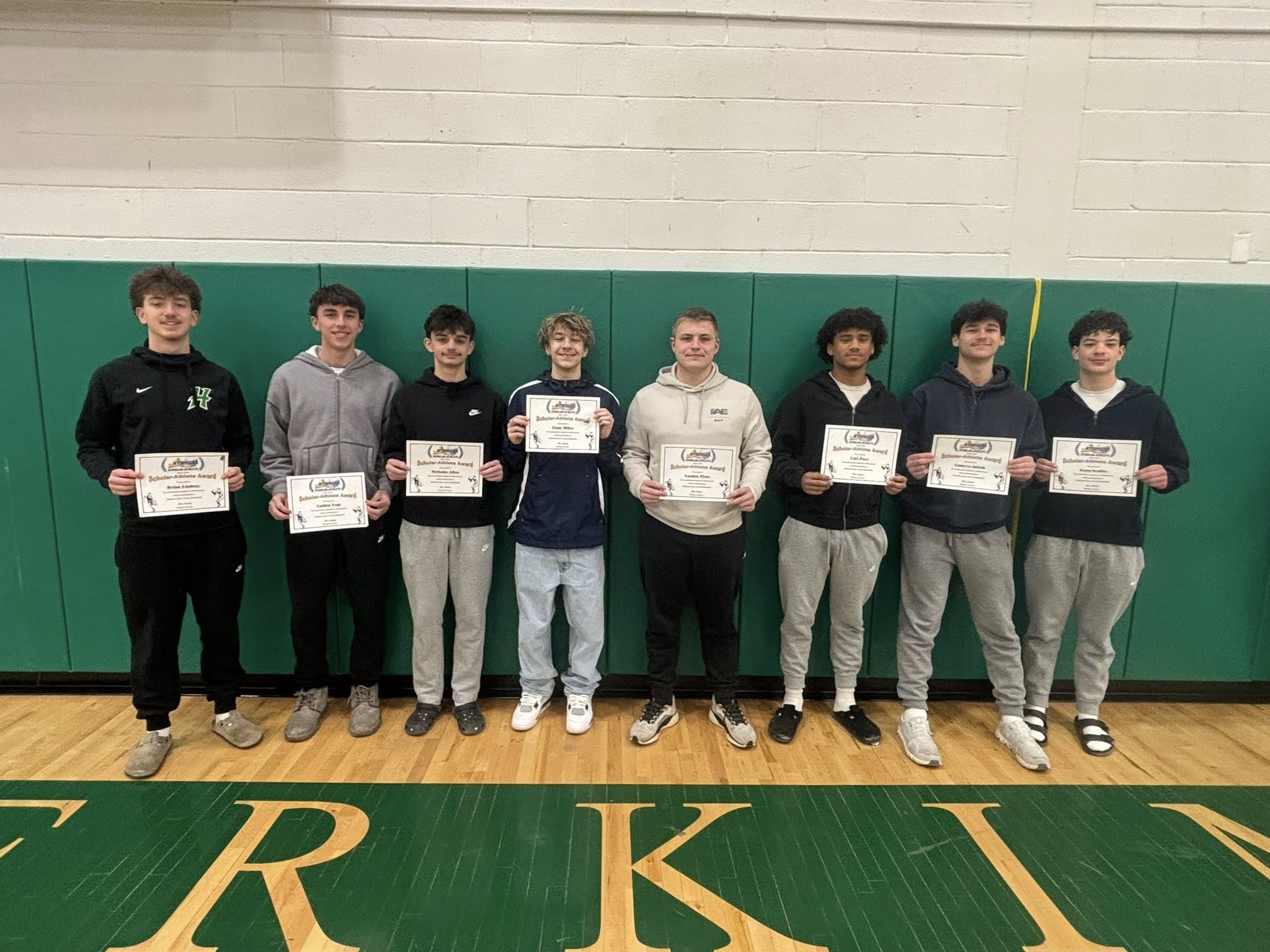 Students posing with scholar athlete certificates