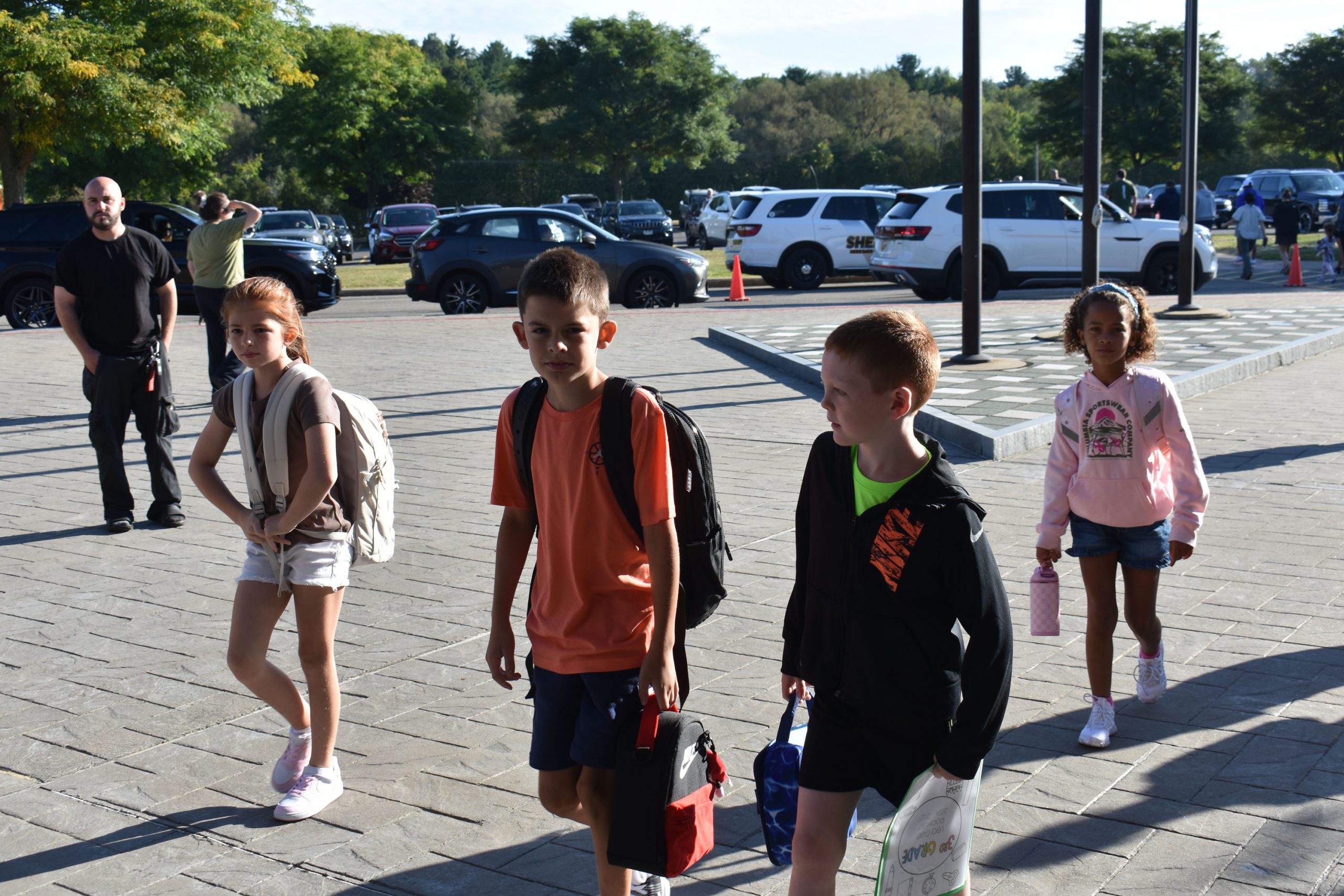 Students walking outside toward the school on the fist day of school