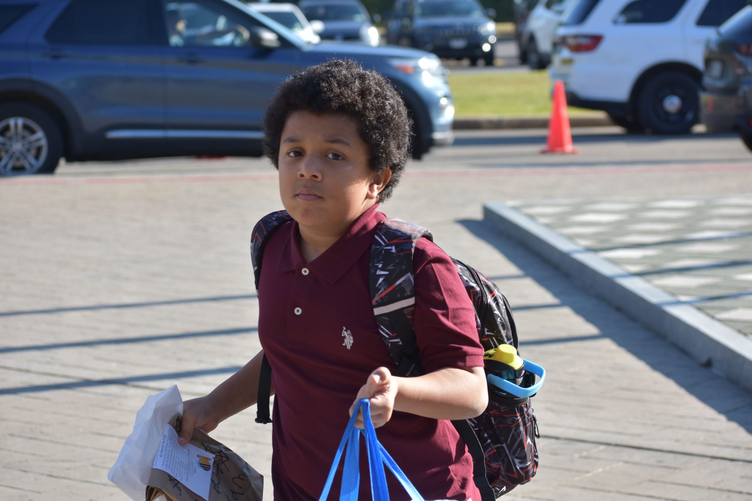 Student walking outside toward the school on the fist day of school