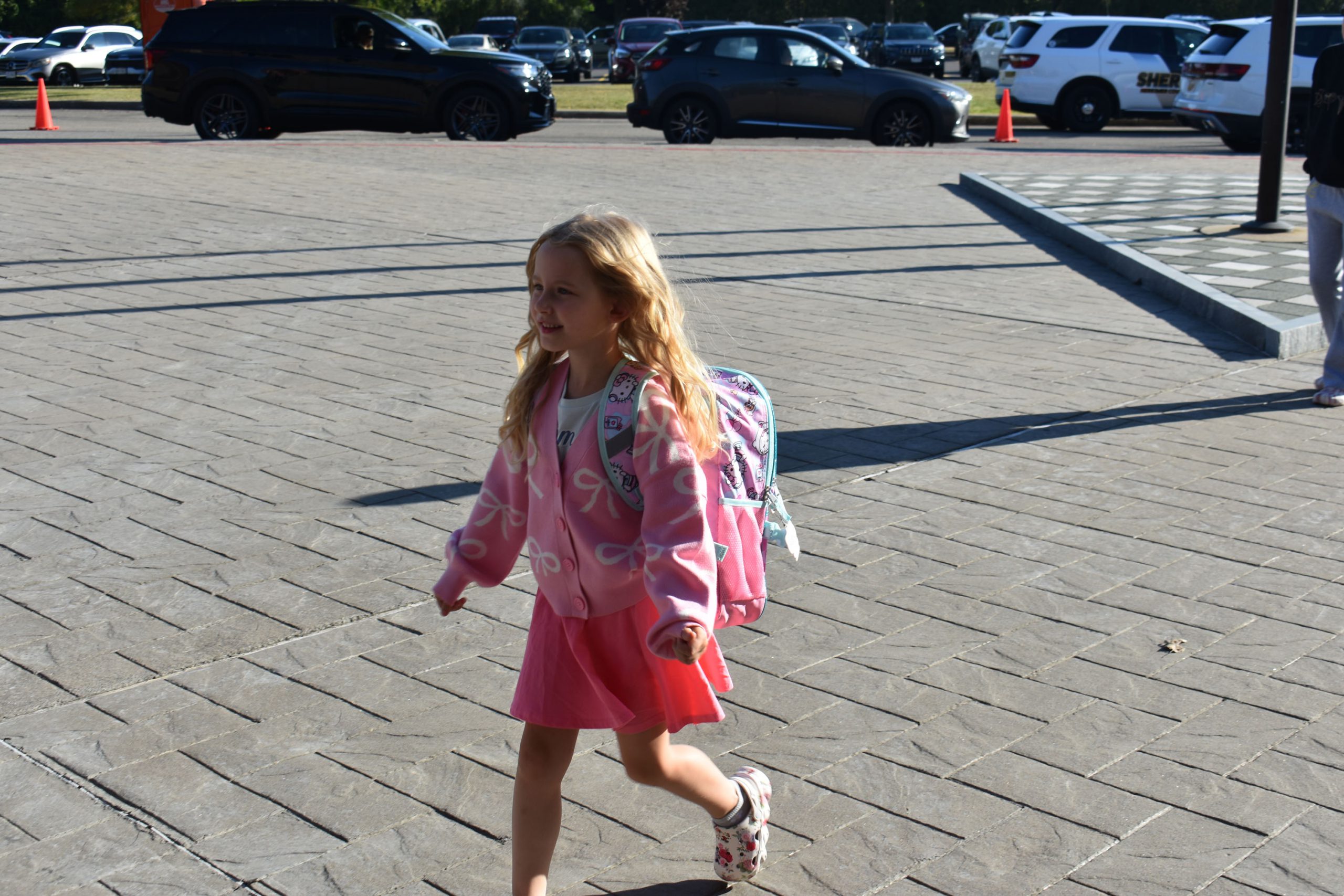 Student walking outside toward the school on the fist day of school