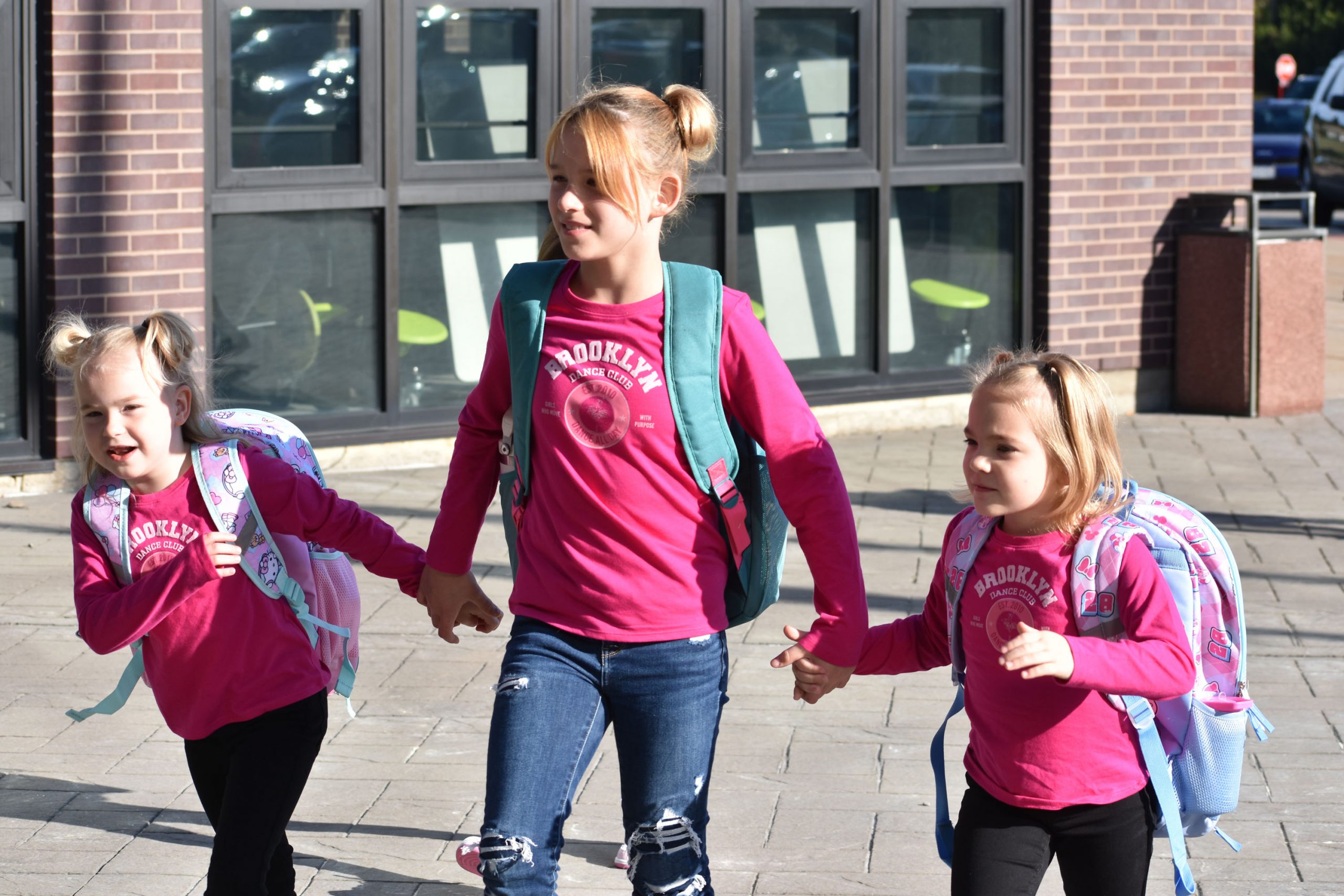Students walking outside toward the school on the fist day of school
