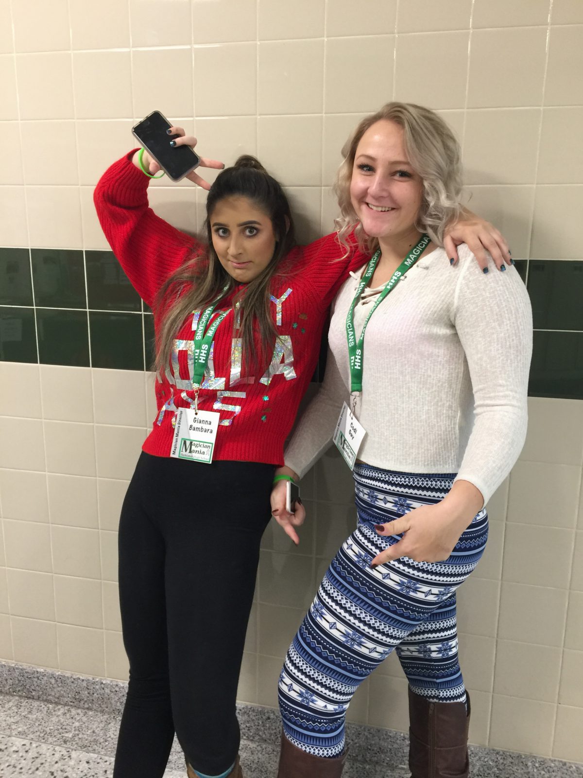 Two seniors pose in the hallway during Magician Mania