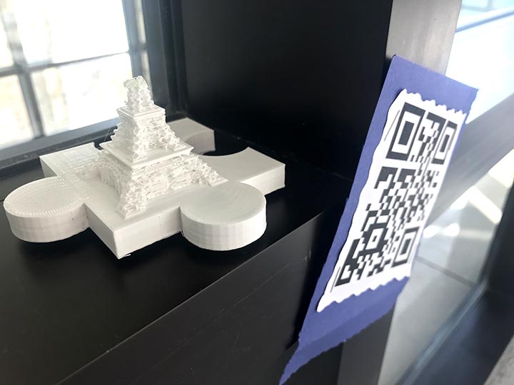 3-D printed model of the Eiffel Tower on a puzzle piece shaped base