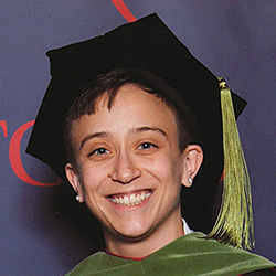 Person smiling wearing mortarboard hat