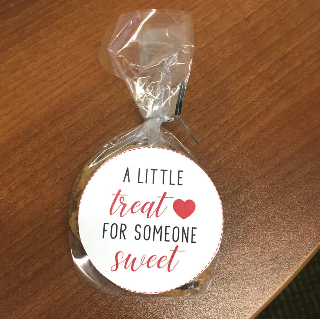 Cookie wrapped in cellophane with sticker that reads, "A little treat for someone sweet"