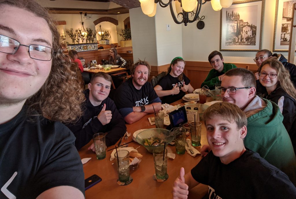 Students pose for a selfie at a restaurant