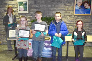 Students hold certificates