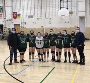 Girls volleyball team posing for a photo