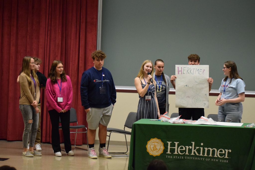 Herkimer students presenting on stage at the Youth Summit at Herkimer College