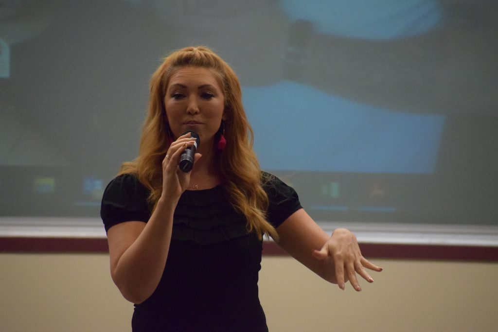 Singer and motivational speaker Jessie Funk performing on stage at the Youth Summit at Herkimer College