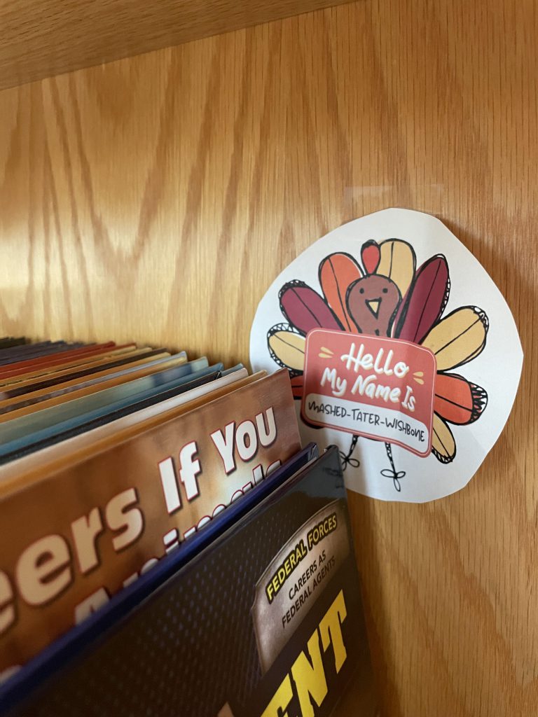 Turkey paper cutout hidden behind books