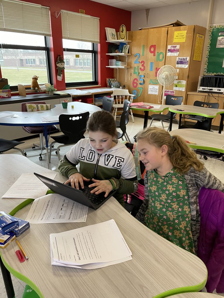 Herkimer fourth graders working on a student newspaper during Newspaper Club
