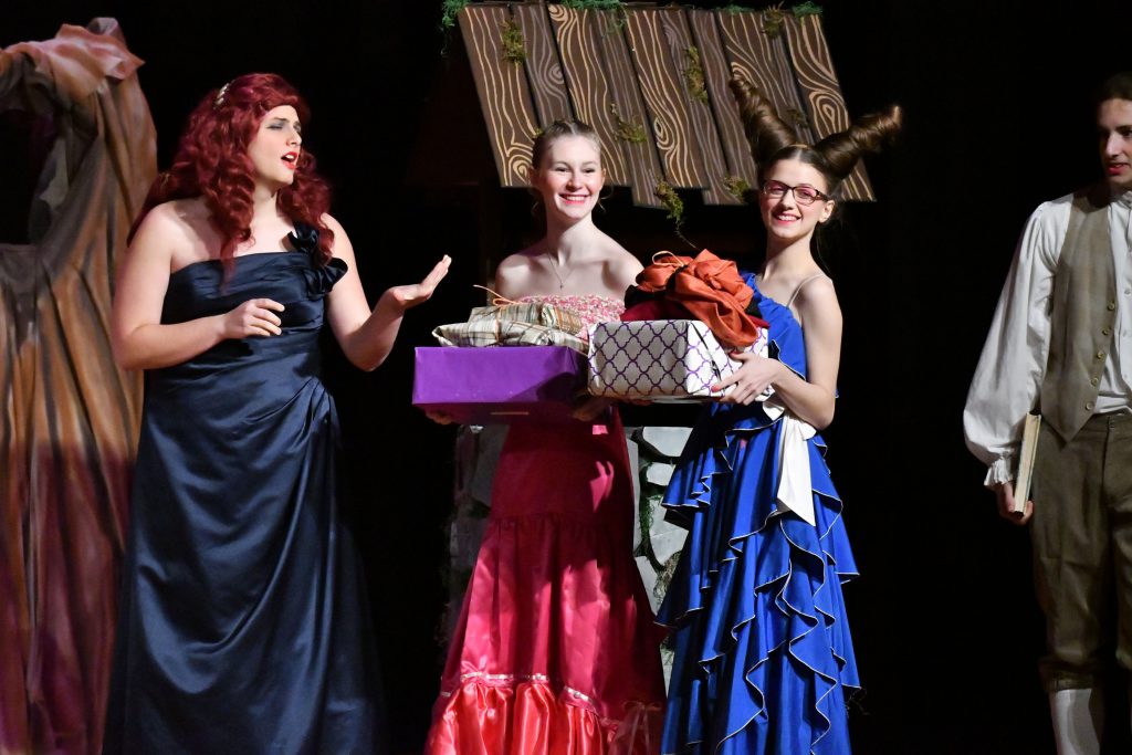Students playing stepmother and stepsisters on stage