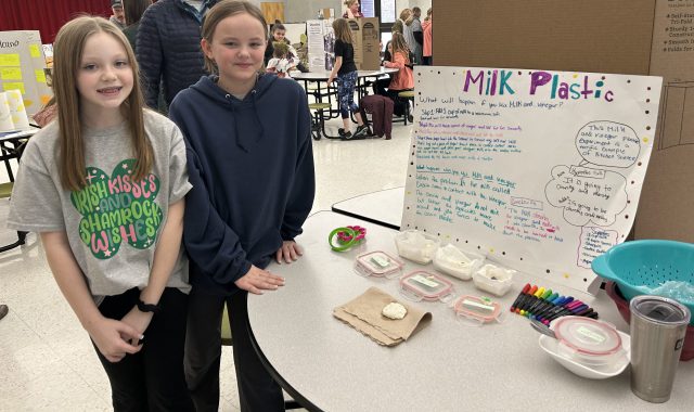 Two students with their display at the science fair