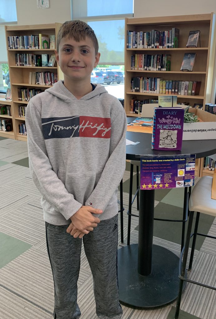 Student posing with his Book Bento in the library