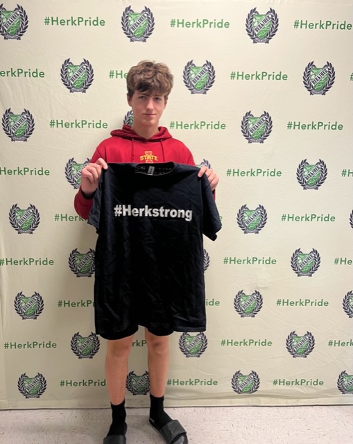 Steven Naegele holding #HerkStrong shirt