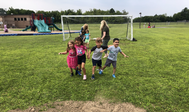 Students racing on a soccer field