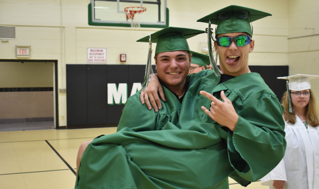 Two students celebrating at graduation