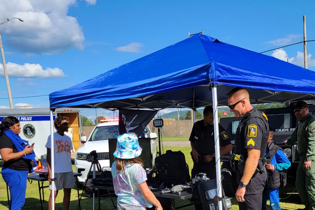 Community members and police at a tent at National Night Out