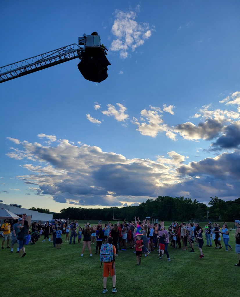 Fire truck about to drop beach balls on community members