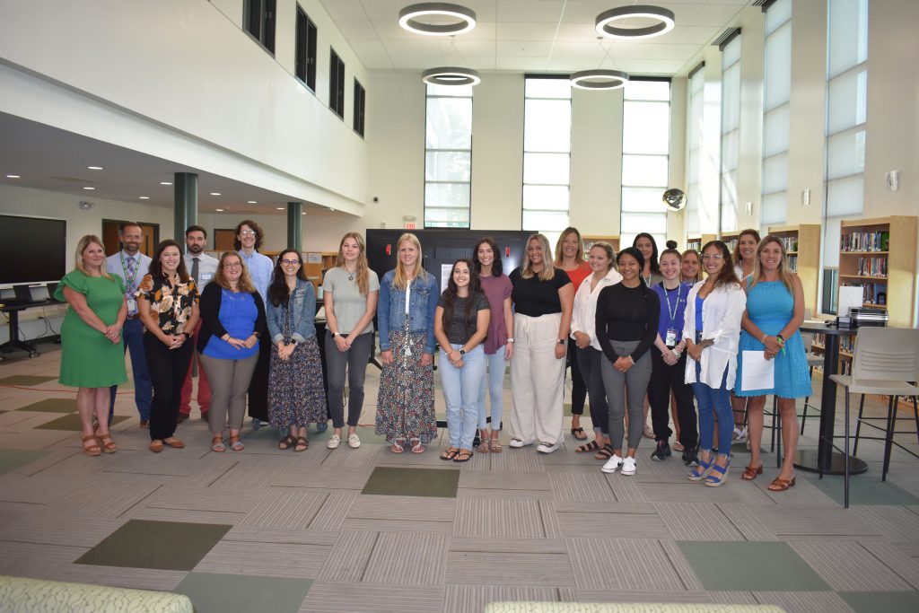 Herkimer CSD administrators pose together with new teachers and staff in the library