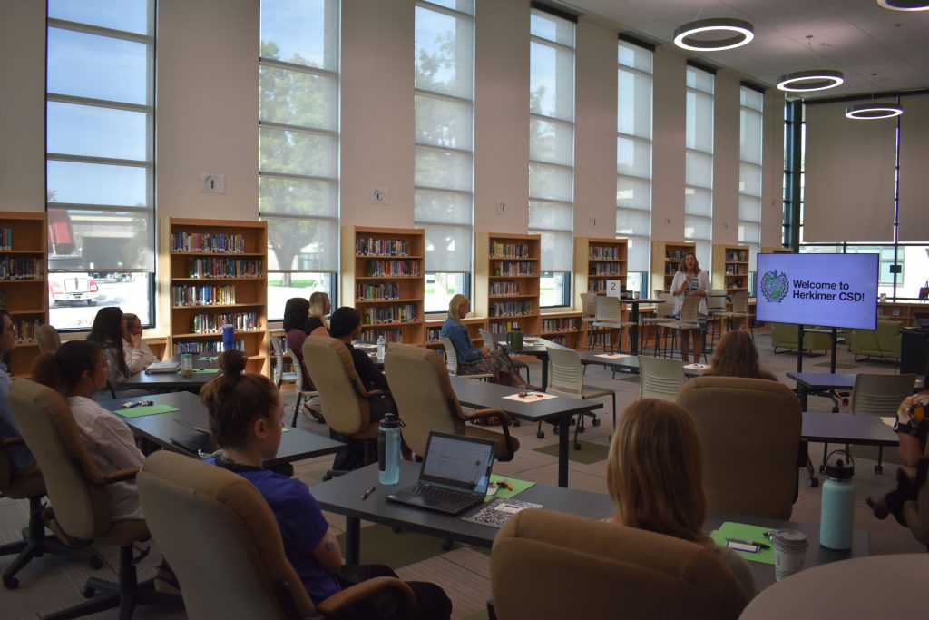 New teachers and staff listening to presentation from Superintendent Kathy Carney