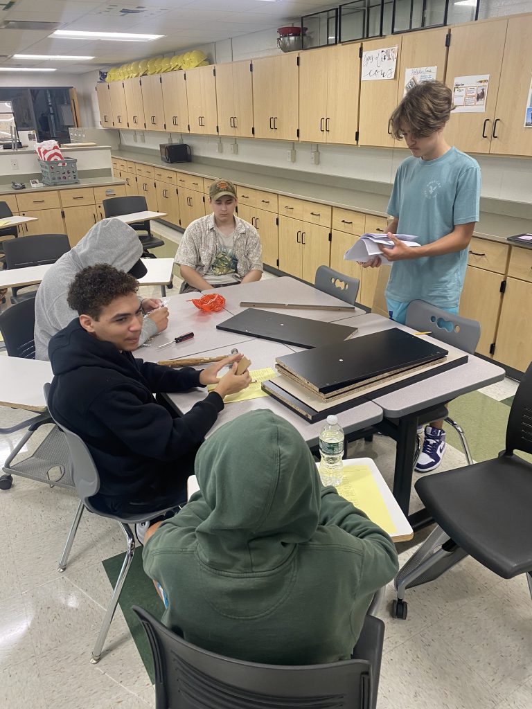 Students putting together bookshelves