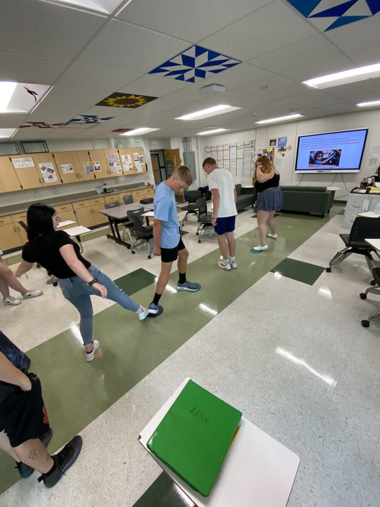 Students doing physical activities in classroom