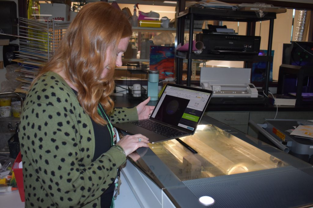 Heather McCutcheon operating a Glowforge