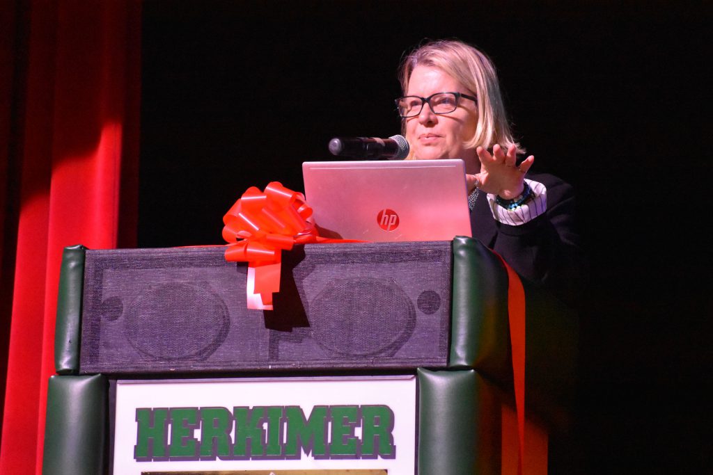 Connected Community School Co-Executive Director Melissa Roys speaks on stage at Connected Community Schools ribbon-cutting ceremony for Herkimer