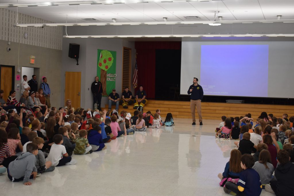 Richard Mathy speaking in front of students at Fire Safety Assembly