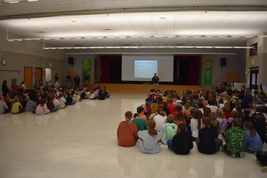 Richard Mathy speaking in front of students at Fire Safety Assembly