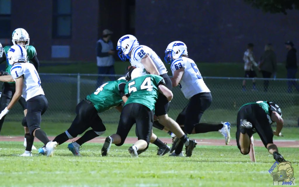 Herkimer senior Michael Goodson making a tackle on the football field with a teammate