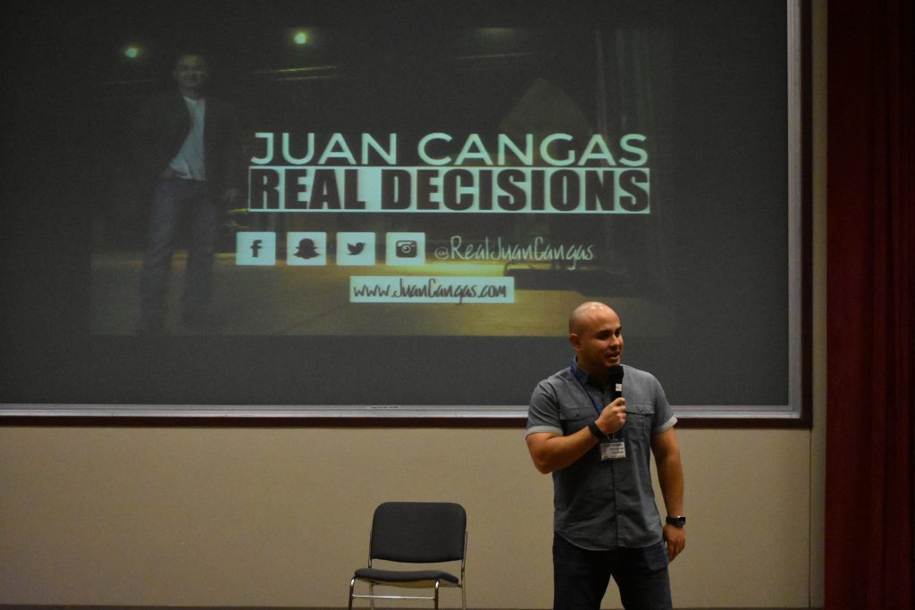 Juan Cangas speaking on stage at Youth Summit