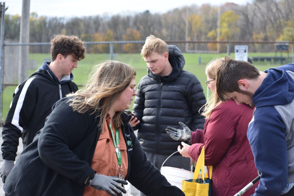 Students and teachers picking up litter at Harmon Park