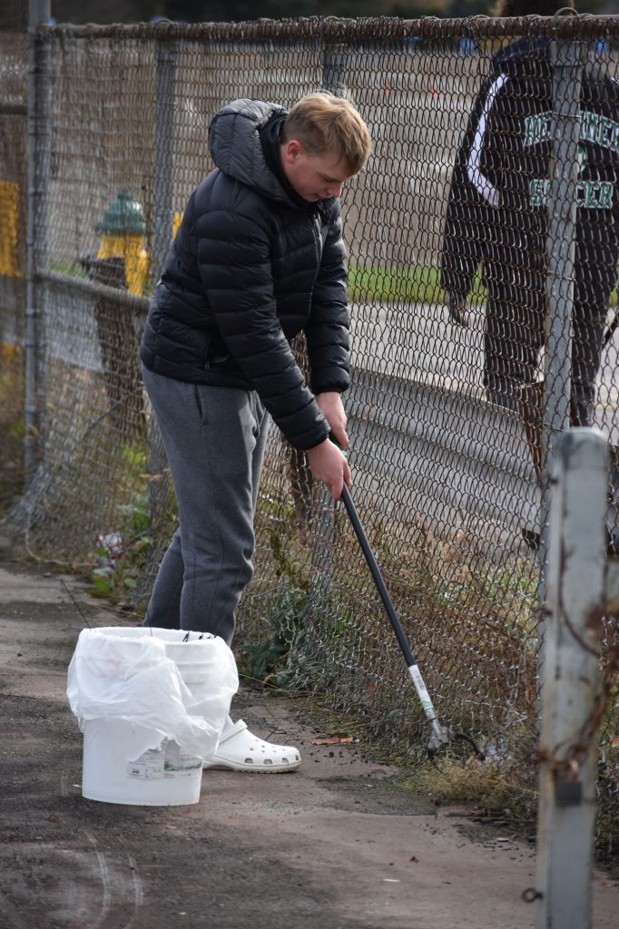 Student picking up litter at Harmon Park