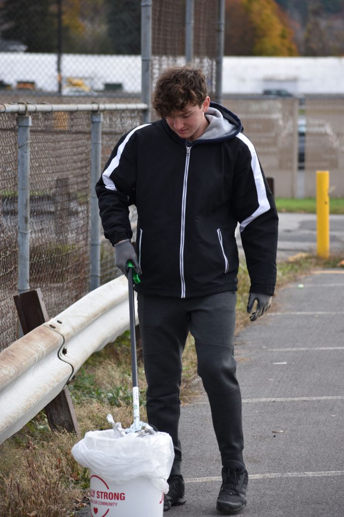 Student picking up litter at Harmon Park