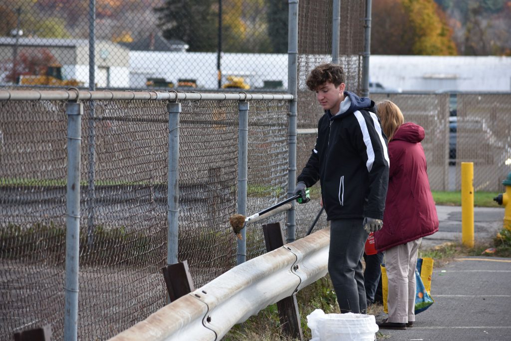 Student picking up litter at Harmon Park