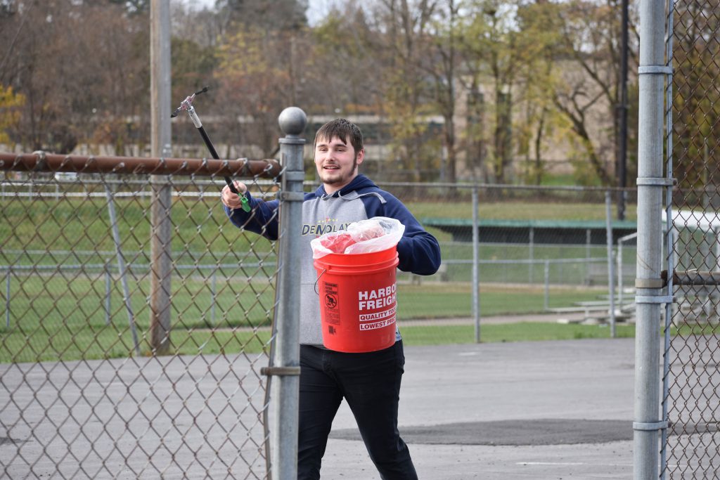 Student picking up litter at Harmon Park