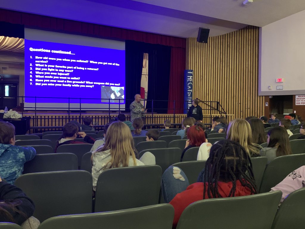 Herkimer teachers Nick Sheldon and Leah Peyton talking to sixth grade students at an assembly