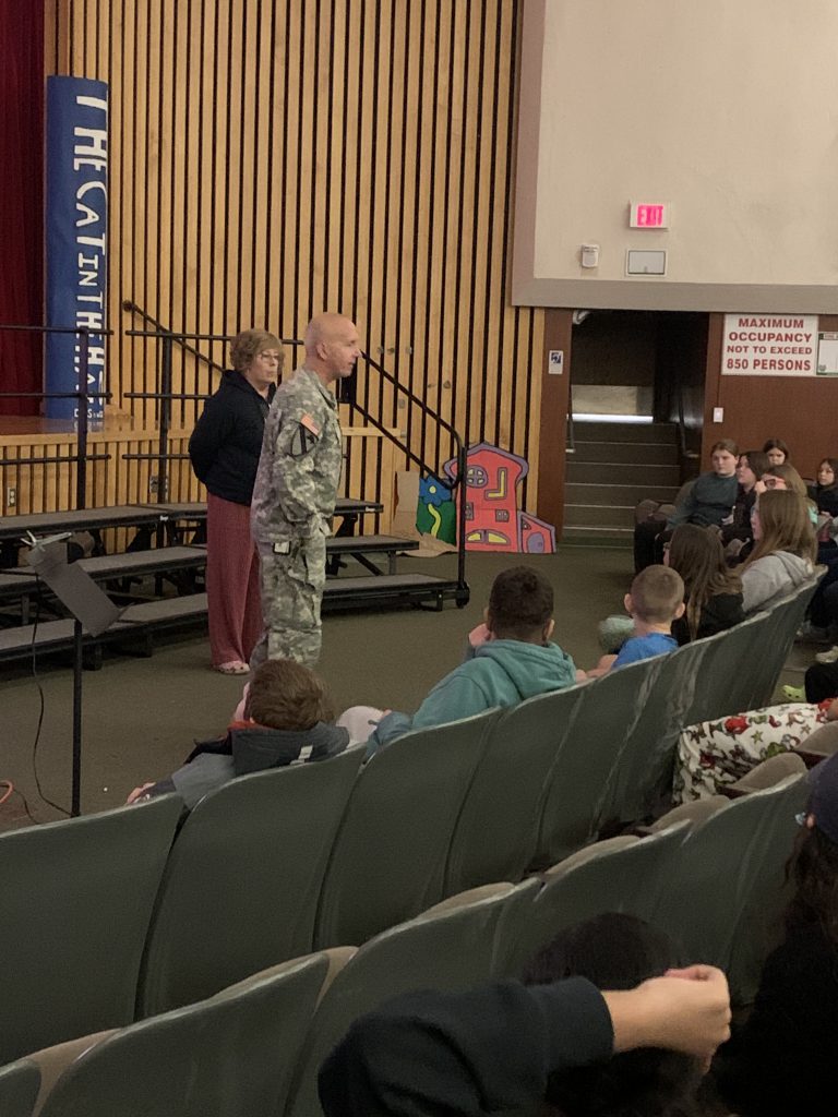 Herkimer teachers Nick Sheldon and Leah Peyton talking to sixth grade students at an assembly