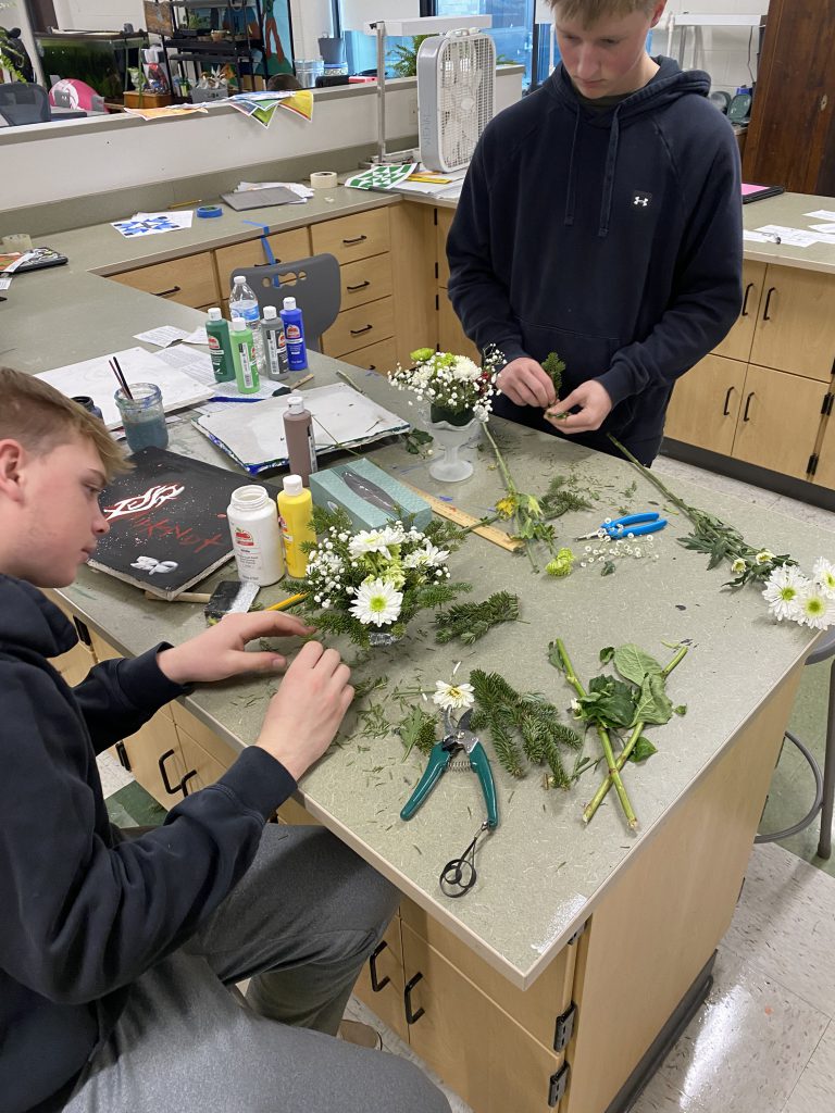 Agriculture students making holiday centerpieces