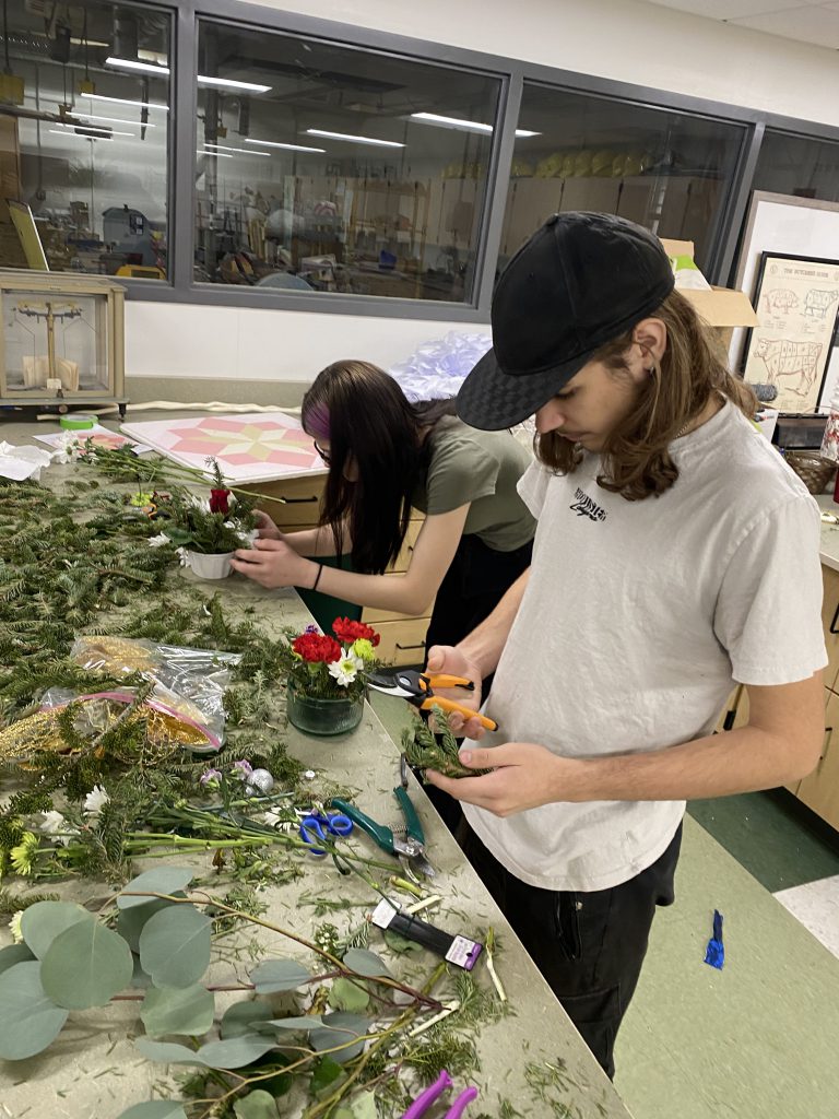 Agriculture students making holiday centerpieces