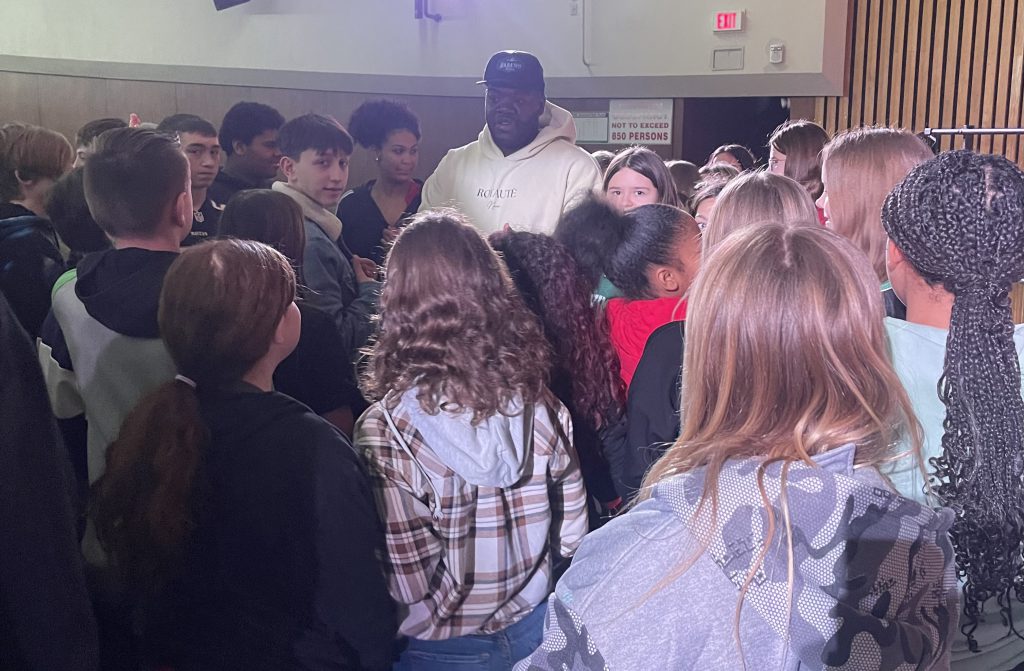 Utica police officer with Herkimer students after being a guest speaker