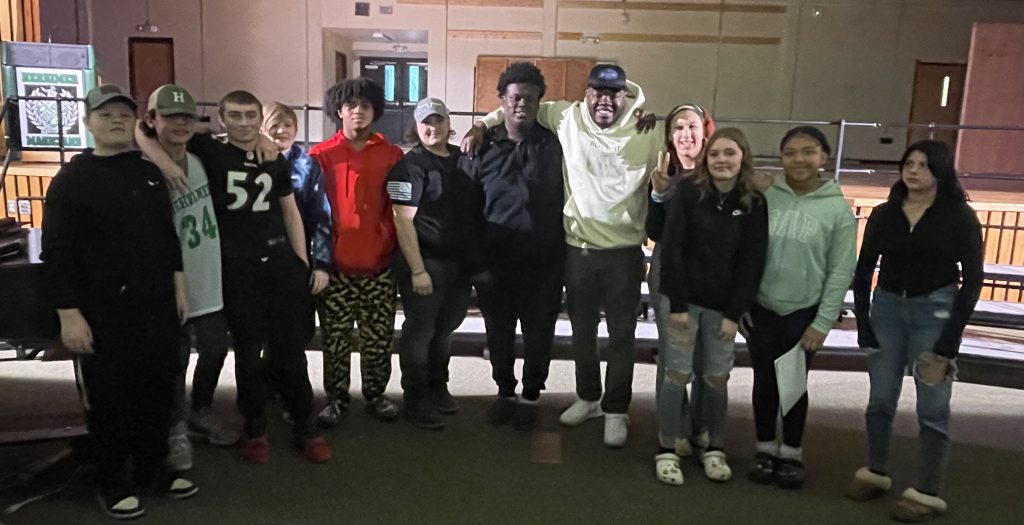 Utica police officer with Herkimer students after being a guest speaker