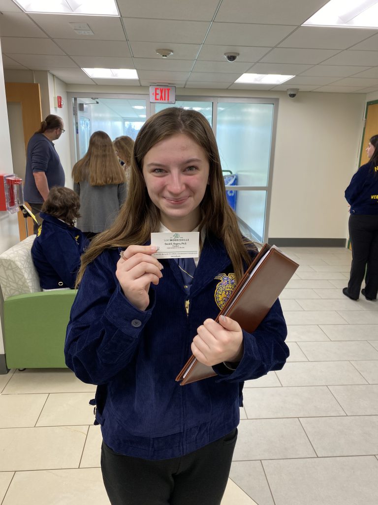 Herkimer FFA member holding business card at state leadership event and competition