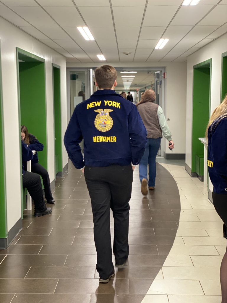 Herkimer FFA member walking at state leadership event and competition