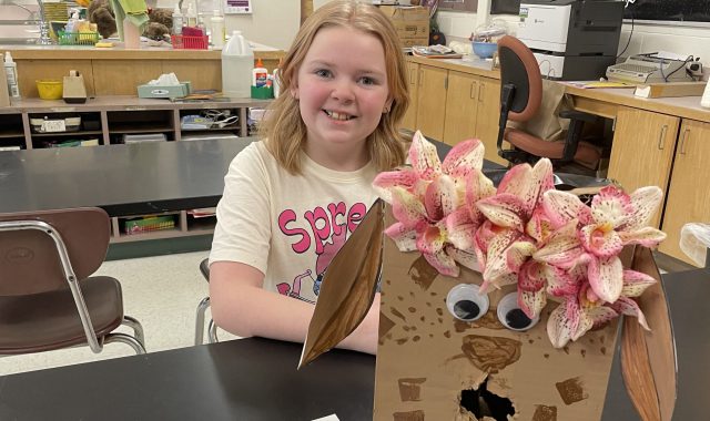 Student posing with her Valentine's Day project