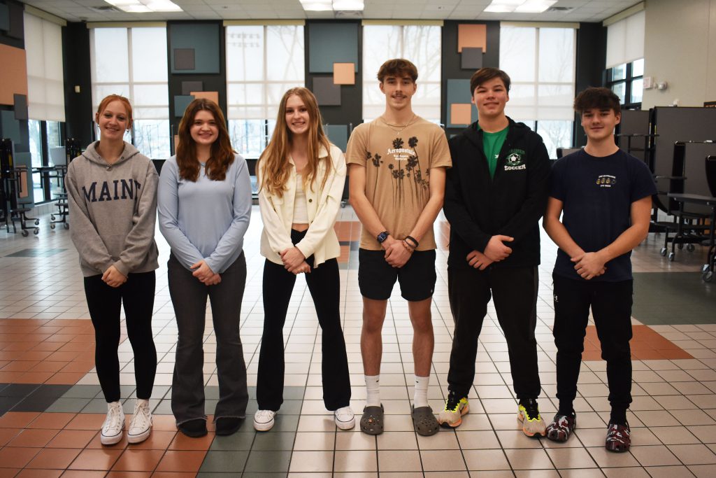 Six indoor track record setters pose together