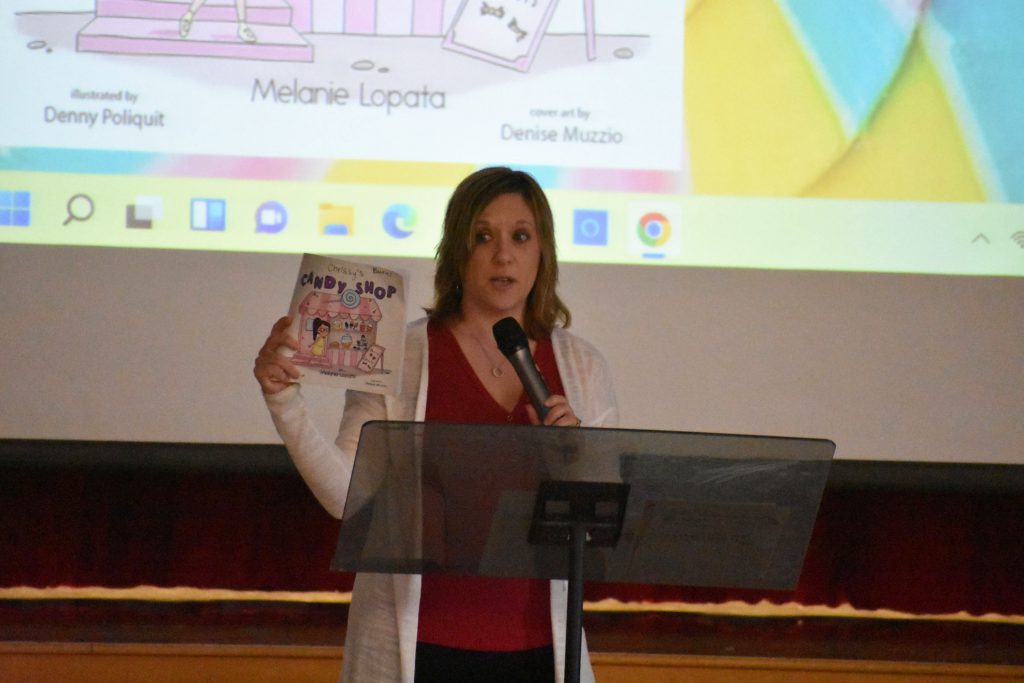 Author Melanie Lopata speaking at school assembly